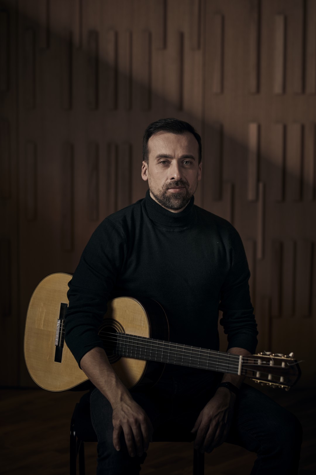 Danijel Cerović seated with guitar